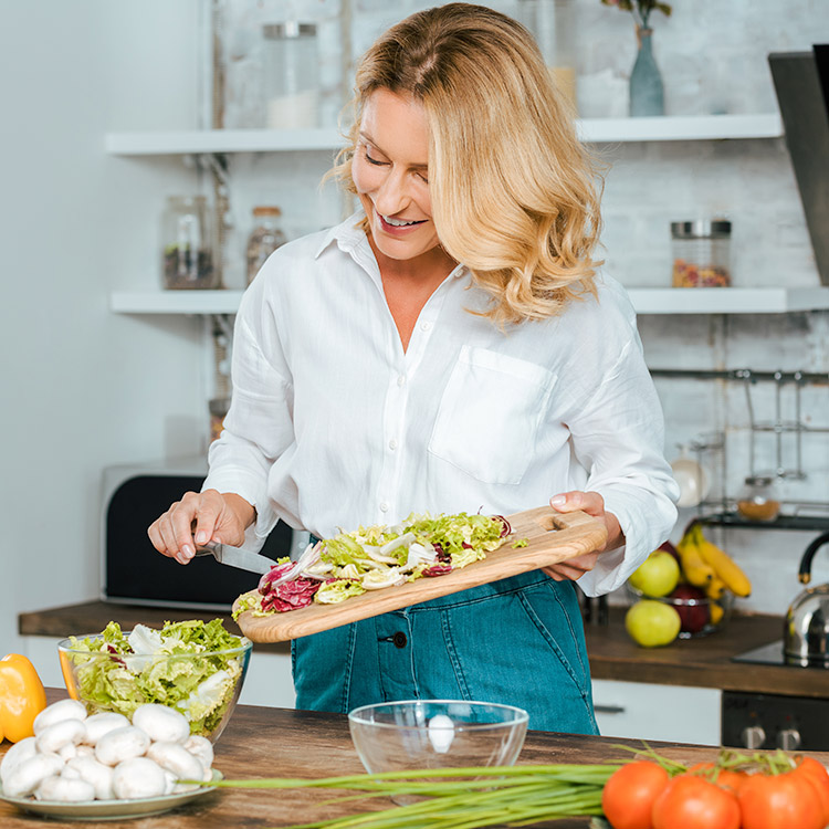 Woman cooking and living stress free due to successful financial planning